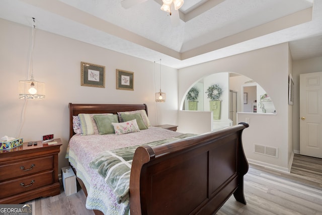 20 Knollwood Pl, Covington, GA 30014 - bedroom with wood finished floors, a ceiling fan, and a raised ceiling