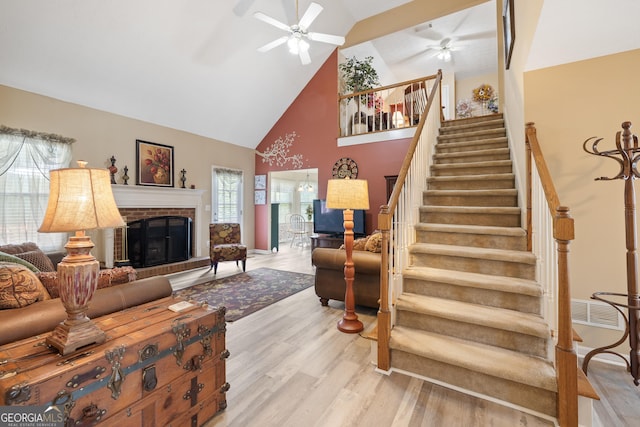 20 Knollwood Pl, Covington, GA 30014 - living area featuring ceiling fan, high vaulted ceiling, light wood-style floors, a brick fireplace, and stairway