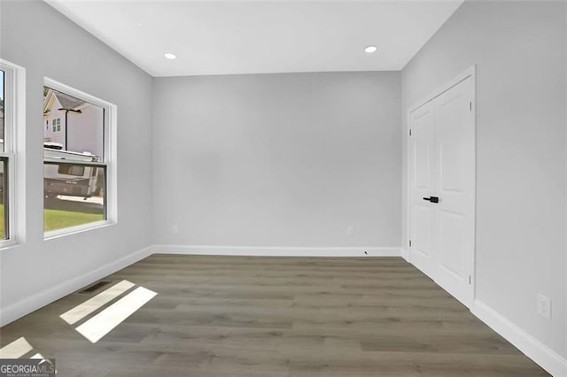 5719 Calm Vly, Flowery Branch, GA 30542 - unfurnished room with wood finished floors and recessed lighting