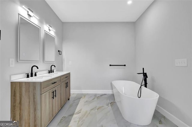 5719 Calm Vly, Flowery Branch, GA 30542 - full bathroom with marble finish flooring, double vanity, a freestanding tub, and recessed lighting