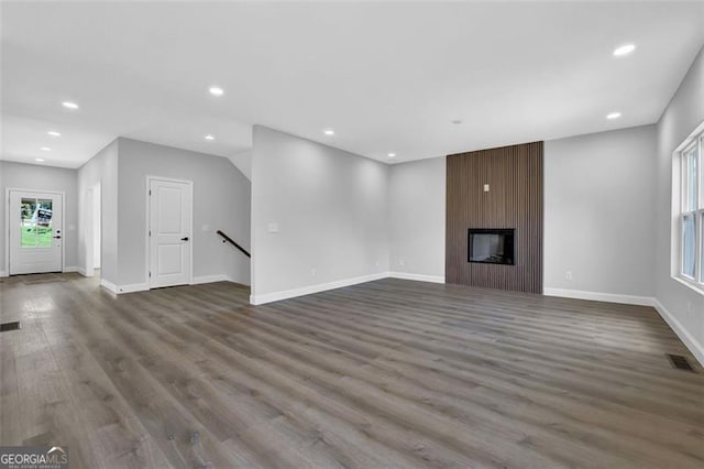 5719 Calm Vly, Flowery Branch, GA 30542 - unfurnished living room with dark wood-style floors, recessed lighting, and a fireplace