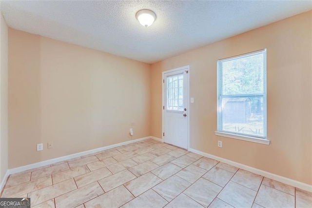 179 Glynn Addy, Stockbridge, GA 30281 - unfurnished room featuring a textured ceiling and light tile patterned floors