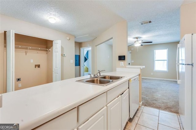 179 Glynn Addy, Stockbridge, GA 30281 - kitchen with white appliances, light colored carpet, a textured ceiling, light countertops, and light tile patterned flooring