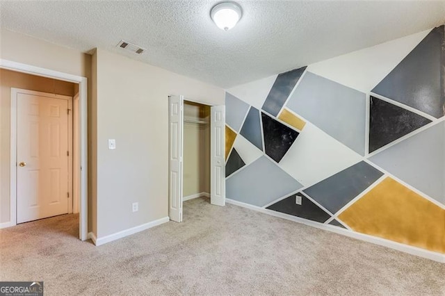 179 Glynn Addy, Stockbridge, GA 30281 - unfurnished bedroom with carpet floors, a textured ceiling, and a closet