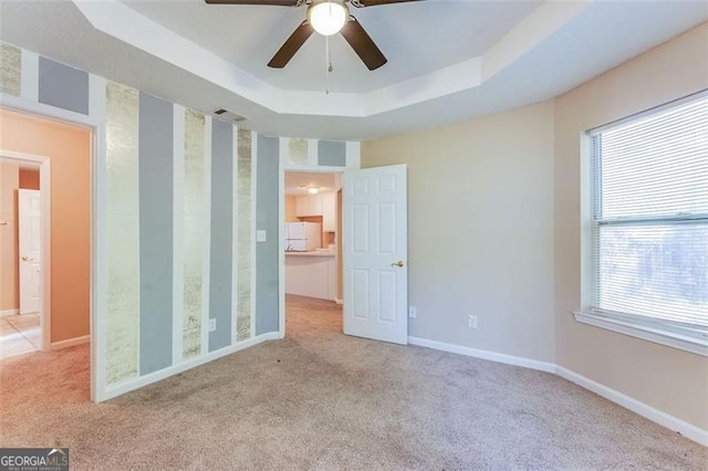 179 Glynn Addy, Stockbridge, GA 30281 - unfurnished bedroom with carpet flooring, a tray ceiling, and freestanding refrigerator