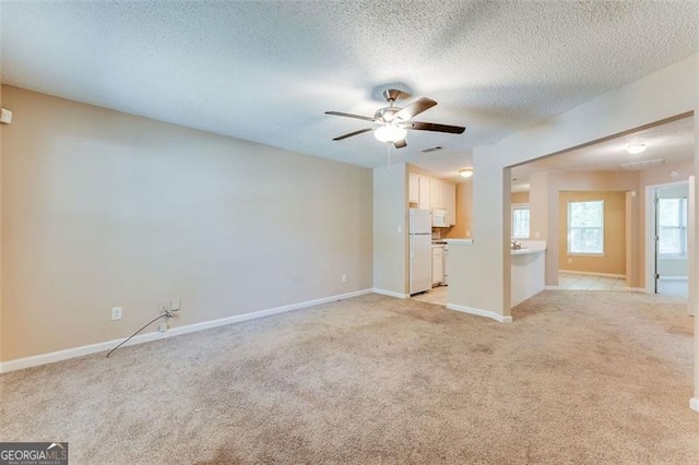 179 Glynn Addy, Stockbridge, GA 30281 - unfurnished living room featuring light carpet, a textured ceiling, and a ceiling fan