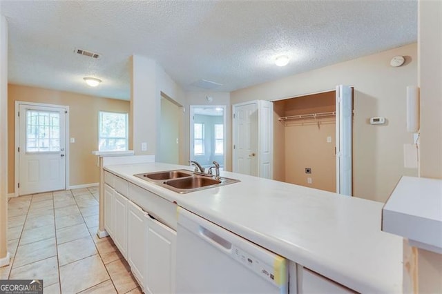 179 Glynn Addy, Stockbridge, GA 30281 - kitchen with white dishwasher, a textured ceiling, white cabinets, light countertops, and light tile patterned flooring