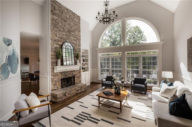 13520 Providence Lk, Alpharetta, GA 30004 - living area with high vaulted ceiling, wood finished floors, a stone fireplace, and a chandelier