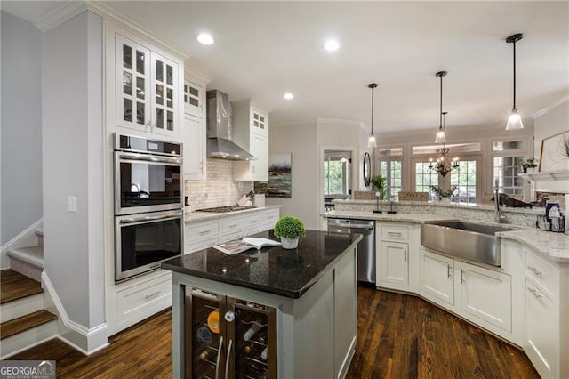 13520 Providence Lk, Alpharetta, GA 30004 - kitchen with stainless steel appliances, wall chimney range hood, beverage cooler, backsplash, and crown molding