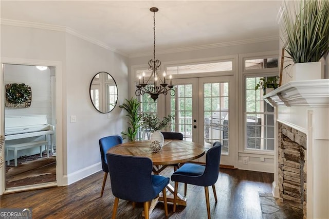 13520 Providence Lk, Alpharetta, GA 30004 - dining room featuring dark wood-style floors, crown molding, french doors, a stone fireplace, and a chandelier