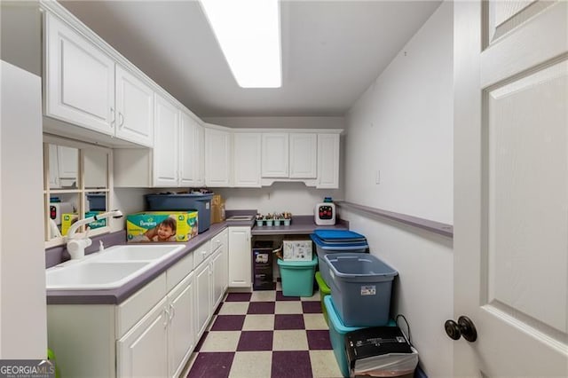 13520 Providence Lk, Alpharetta, GA 30004 - kitchen with light floors, white cabinetry, and light countertops