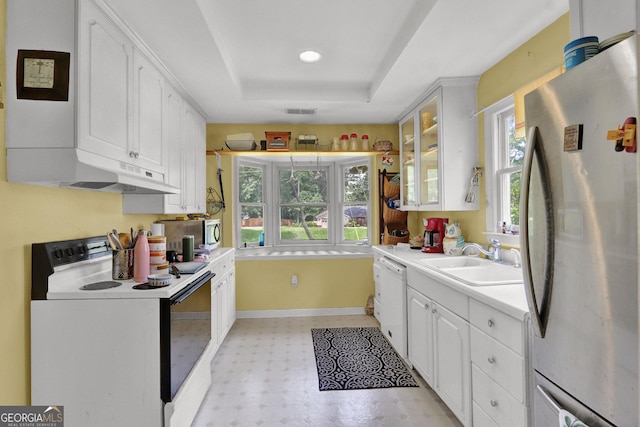 4636 Chamblee Tucker Rd, Tucker, GA 30084 - kitchen featuring stainless steel appliances, a tray ceiling, white cabinets, light floors, and light countertops
