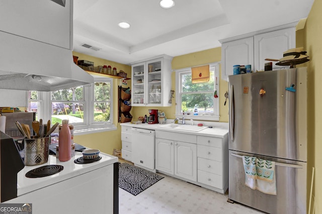 4636 Chamblee Tucker Rd, Tucker, GA 30084 - kitchen with white appliances, ventilation hood, white cabinets, light countertops, and glass insert cabinets