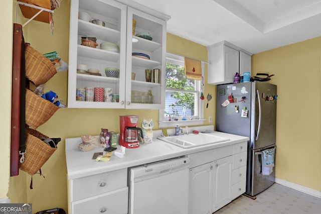 4636 Chamblee Tucker Rd, Tucker, GA 30084 - kitchen with dishwasher, freestanding refrigerator, light floors, light countertops, and white cabinetry