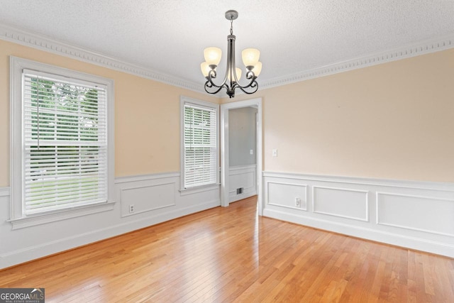 829 Bev Ct, Lawrenceville, GA 30046 - spare room with a chandelier, light wood finished floors, plenty of natural light, crown molding, and a wainscoted wall