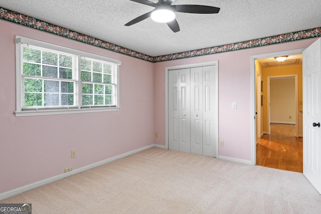 829 Bev Ct, Lawrenceville, GA 30046 - unfurnished bedroom with a textured ceiling, carpet flooring, a closet, and ceiling fan