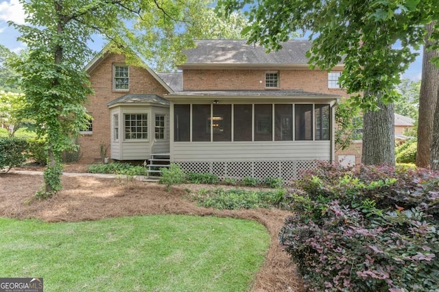 829 Bev Ct, Lawrenceville, GA 30046 - back of house with a sunroom, a lawn, and roof with shingles