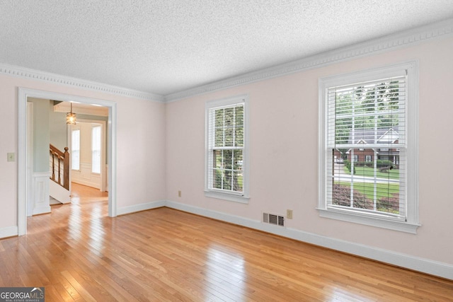 829 Bev Ct, Lawrenceville, GA 30046 - empty room featuring a textured ceiling, light wood-style flooring, and plenty of natural light