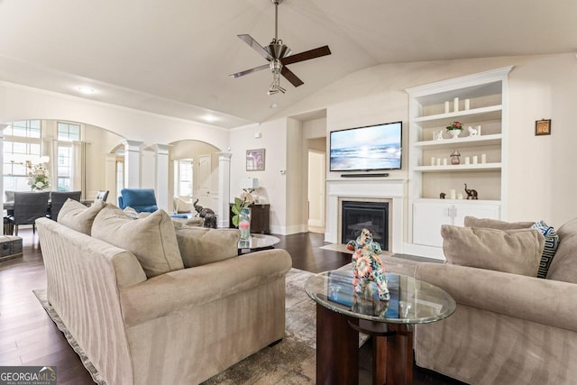 2844 Bluestone Dr SW, South Fulton, GA 30331 - living room featuring a ceiling fan, arched walkways, decorative columns, lofted ceiling, and a fireplace with flush hearth