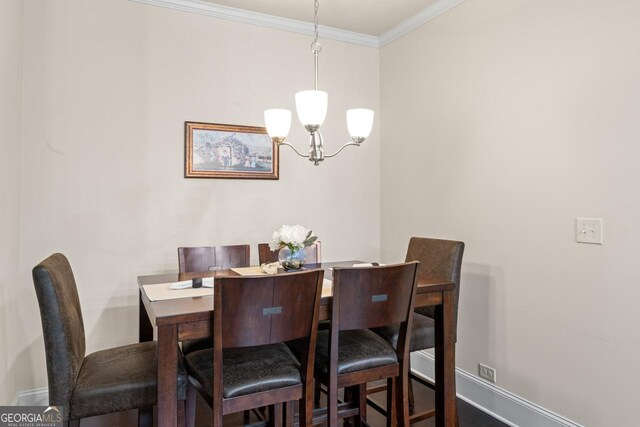 2844 Bluestone Dr SW, South Fulton, GA 30331 - dining area featuring a chandelier and crown molding