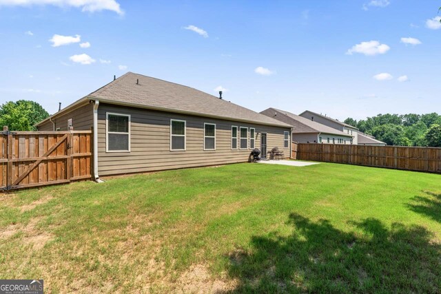 2844 Bluestone Dr SW, South Fulton, GA 30331 - back of house with a fenced backyard and a patio area