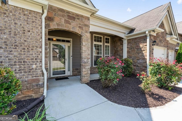 2844 Bluestone Dr SW, South Fulton, GA 30331 - entrance to property featuring stone siding, a garage, covered porch, and a shingled roof