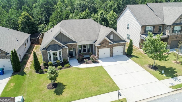 2844 Bluestone Dr SW, South Fulton, GA 30331 - craftsman inspired home with board and batten siding, stone siding, an attached garage, concrete driveway, and a front yard