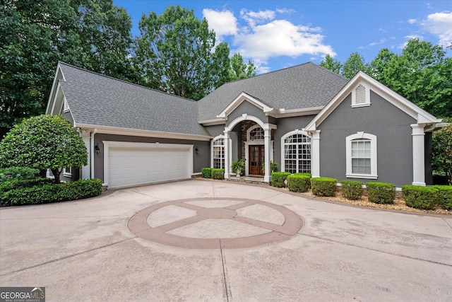 9125 Patrick Pl, Winston, GA 30187 - view of front of house featuring a shingled roof, curved driveway, stucco siding, and an attached garage
