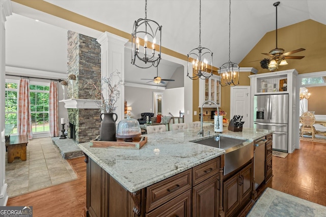 9125 Patrick Pl, Winston, GA 30187 - kitchen featuring stainless steel appliances, ceiling fan, a chandelier, high vaulted ceiling, and healthy amount of natural light