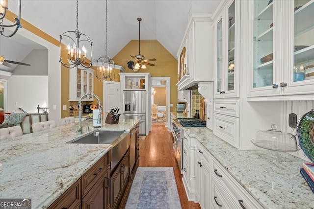 9125 Patrick Pl, Winston, GA 30187 - kitchen featuring a ceiling fan, stainless steel appliances, high vaulted ceiling, wood finished floors, and a chandelier