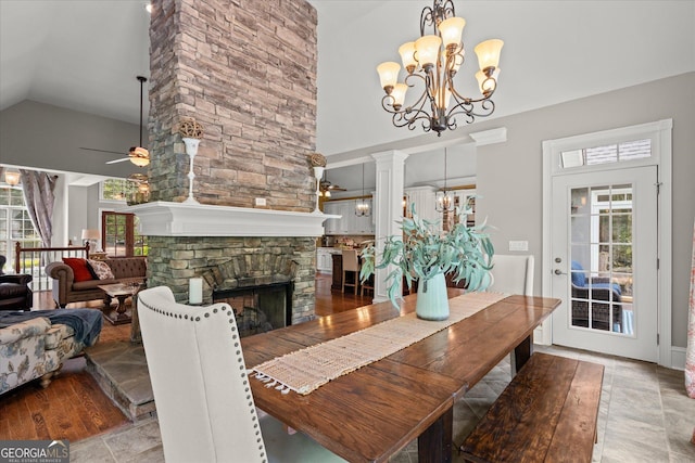 9125 Patrick Pl, Winston, GA 30187 - dining space featuring a chandelier, plenty of natural light, ceiling fan, high vaulted ceiling, and a stone fireplace