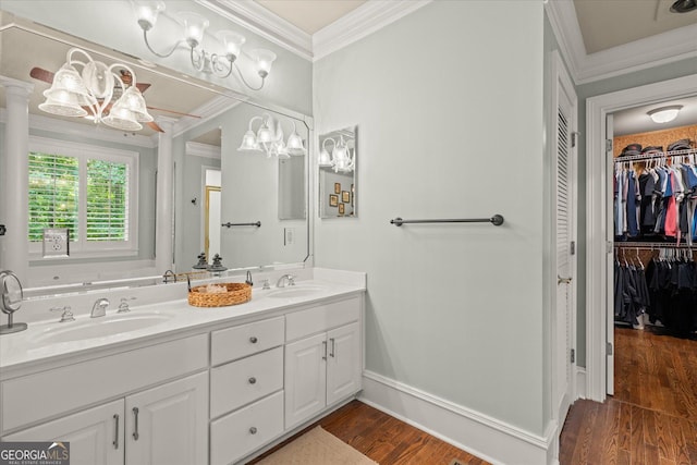 9125 Patrick Pl, Winston, GA 30187 - full bathroom featuring ornamental molding, double vanity, wood finished floors, a spacious closet, and a chandelier