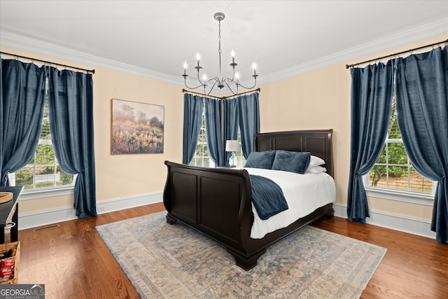 9125 Patrick Pl, Winston, GA 30187 - bedroom featuring a chandelier, multiple windows, ornamental molding, and wood finished floors
