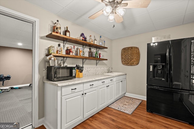 9125 Patrick Pl, Winston, GA 30187 - indoor dry bar with black appliances, a ceiling fan, light wood-style flooring, and a drop ceiling