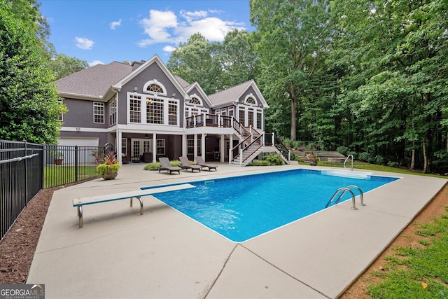 9125 Patrick Pl, Winston, GA 30187 - view of pool featuring stairway, a patio, a diving board, a deck, and a sunroom