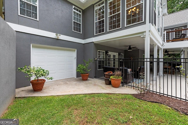 9125 Patrick Pl, Winston, GA 30187 - rear view of house with stucco siding, an attached garage, and ceiling fan