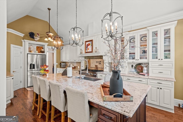 9125 Patrick Pl, Winston, GA 30187 - kitchen with stainless steel refrigerator with ice dispenser, a chandelier, white cabinetry, glass insert cabinets, and high vaulted ceiling