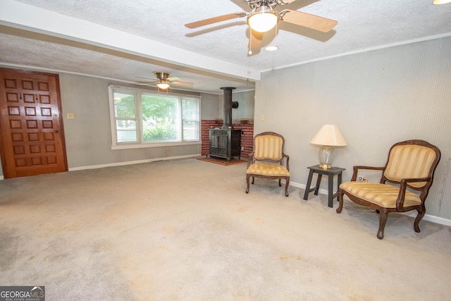 195 Hudgen Rd, Newnan, GA 30265 - living area featuring a wood stove, a textured ceiling, carpet floors, and ceiling fan