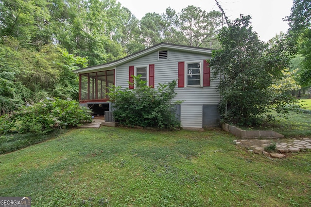 195 Hudgen Rd, Newnan, GA 30265 - view of front of home with a sunroom and a front lawn