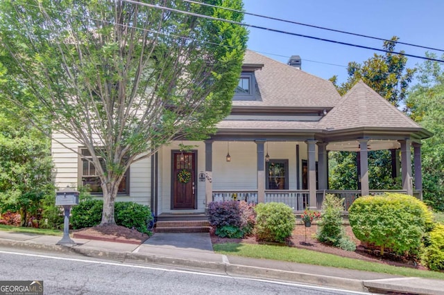 260 W Peachtree St, Norcross, GA 30071 - view of front of home featuring covered porch, roof with shingles, and a chimney