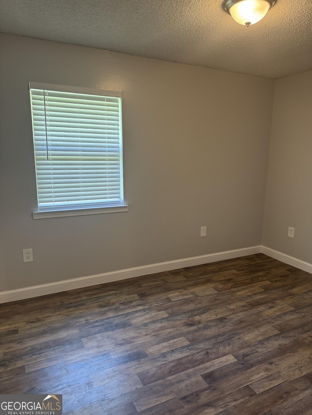 1013 E Cumberland Ct, Bainbridge, GA 39817 - unfurnished room with dark wood-style floors and a textured ceiling