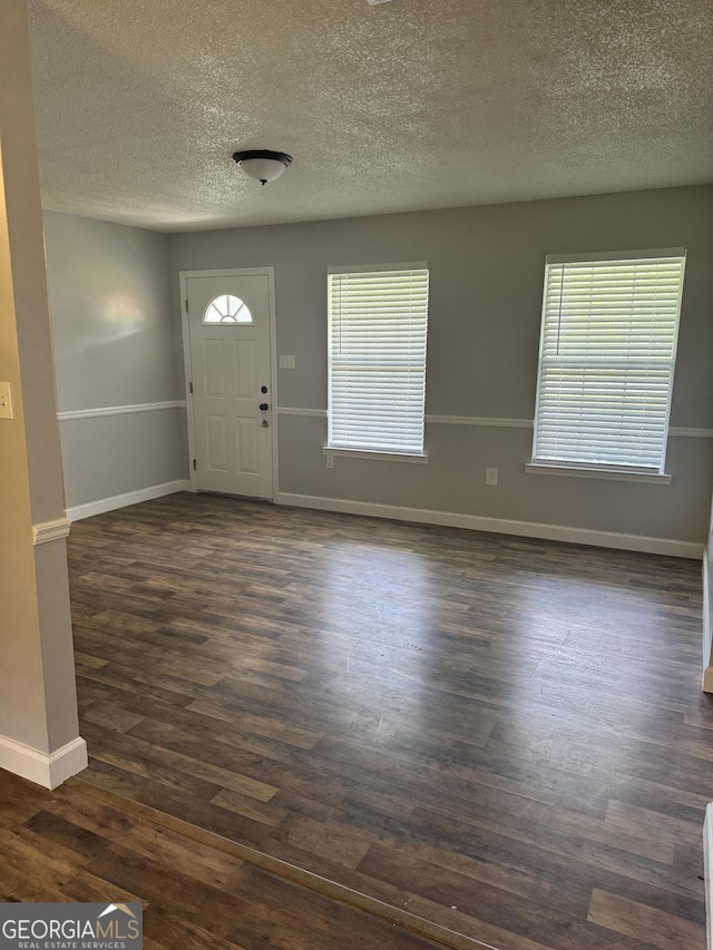 1013 E Cumberland Ct, Bainbridge, GA 39817 - entrance foyer featuring a textured ceiling and dark wood-type flooring