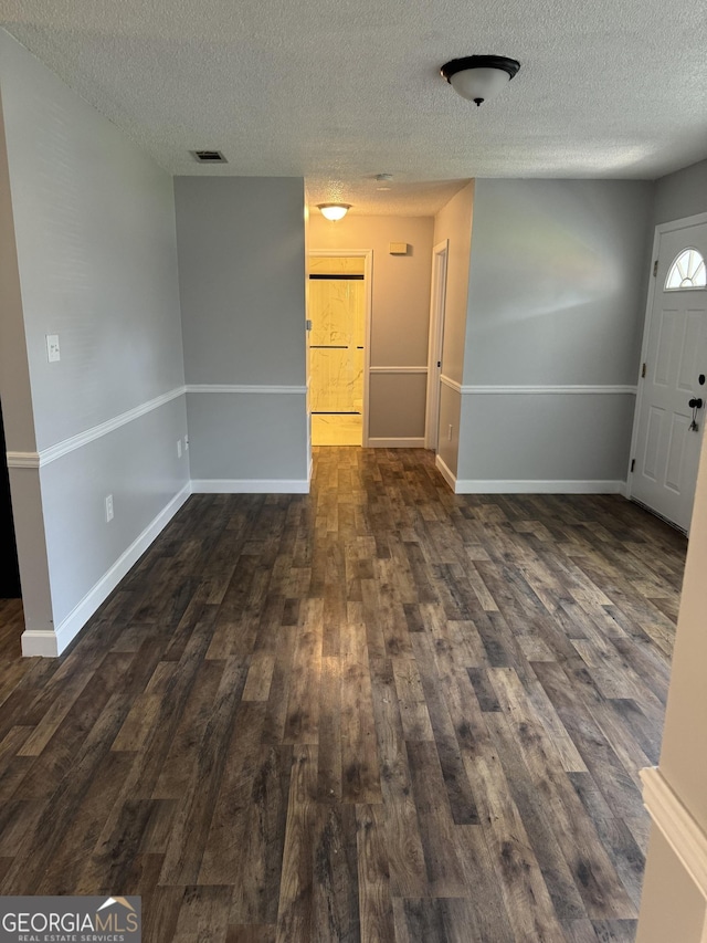 1013 E Cumberland Ct, Bainbridge, GA 39817 - entrance foyer with a textured ceiling and dark wood-style flooring
