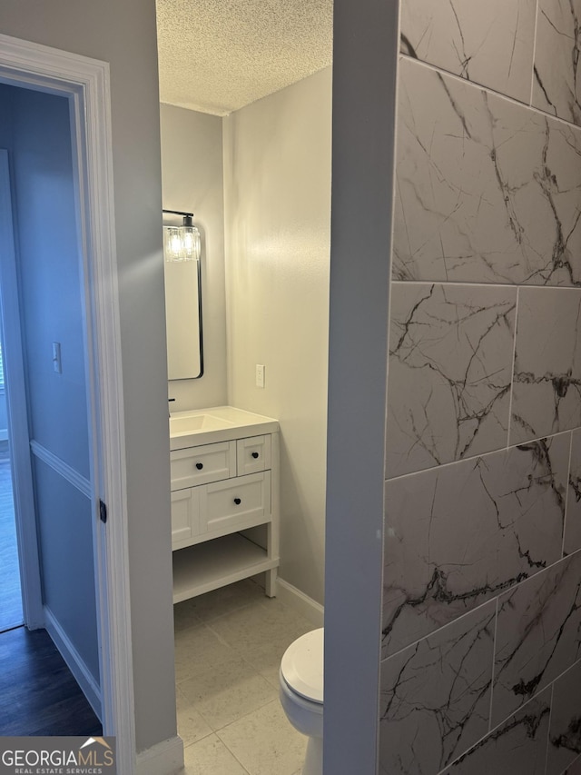 1013 E Cumberland Ct, Bainbridge, GA 39817 - bathroom with vanity and a textured ceiling