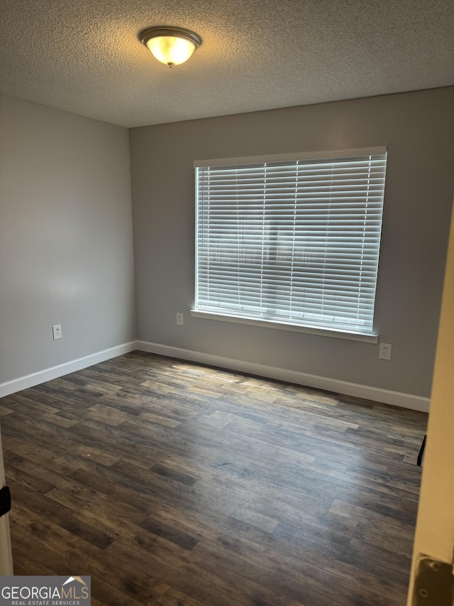 1013 E Cumberland Ct, Bainbridge, GA 39817 - unfurnished room with dark wood finished floors and a textured ceiling