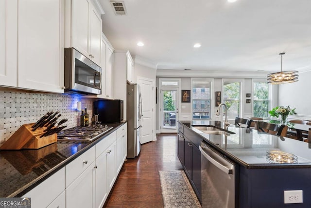 2520 Carmel Way, Alpharetta, GA 30009 - kitchen featuring stainless steel appliances, crown molding, white cabinets, tasteful backsplash, and dark wood finished floors