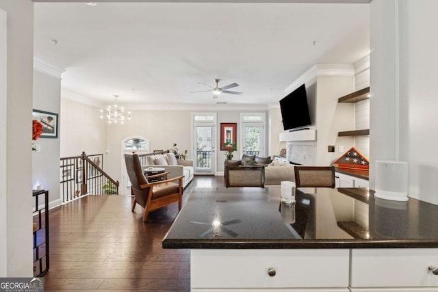 2520 Carmel Way, Alpharetta, GA 30009 - kitchen with crown molding, ceiling fan, dark wood-style floors, white cabinets, and a fireplace