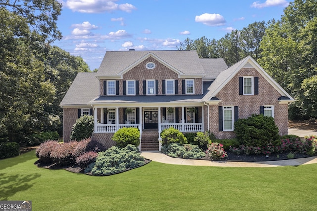 4759 Highland Point Dr, Auburn, GA 30011 - view of front facade with brick siding, covered porch, and a front lawn