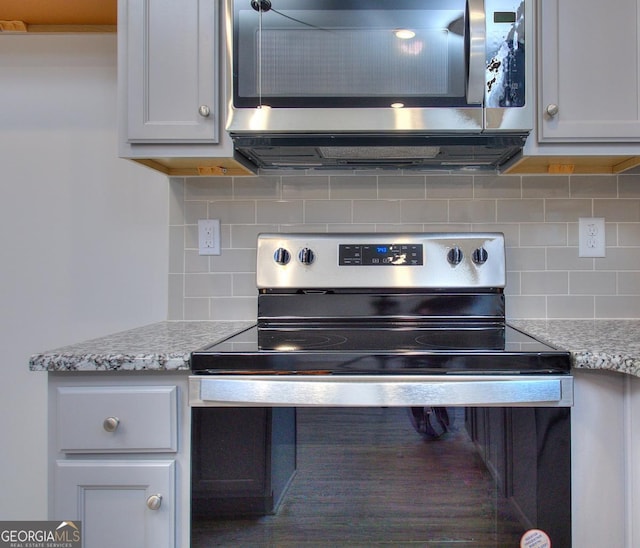 117 Greenview Ct Unit 1302, Homer, GA 30547 - detailed view of appliances with stainless steel finishes, tasteful backsplash, and light stone countertops