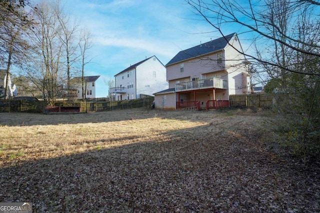 860 Sweet Mill Ln, Lawrenceville, GA 30045 - back of property featuring a fenced backyard and a balcony